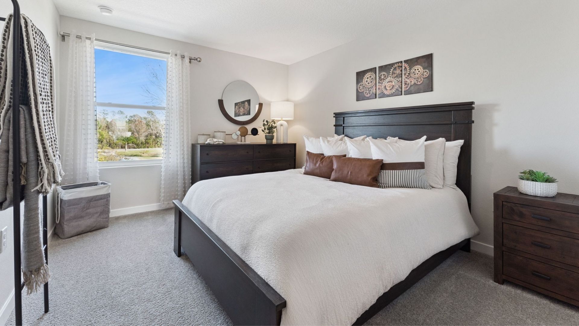 Guest bedroom with bed, nighstands and natural lighting.