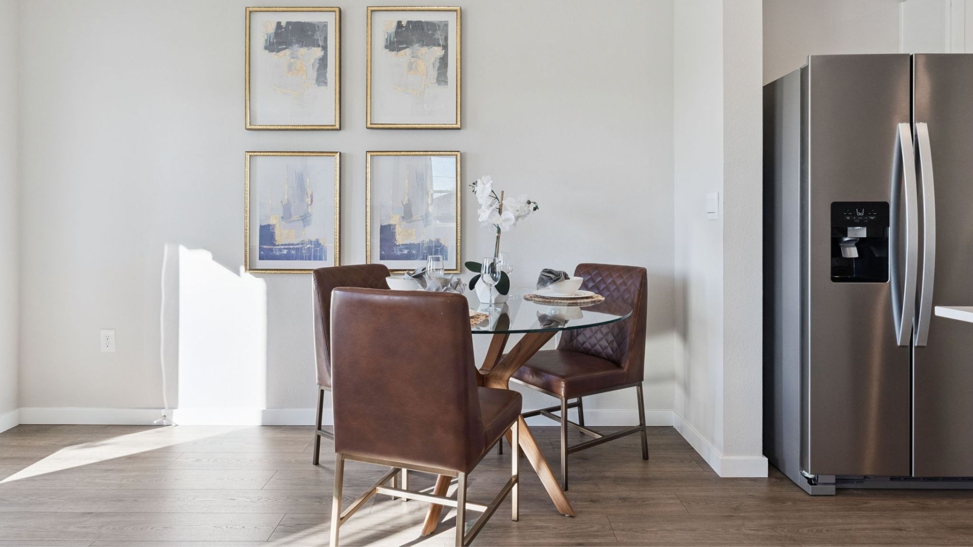dining room table with laminate flooring and quartz counters