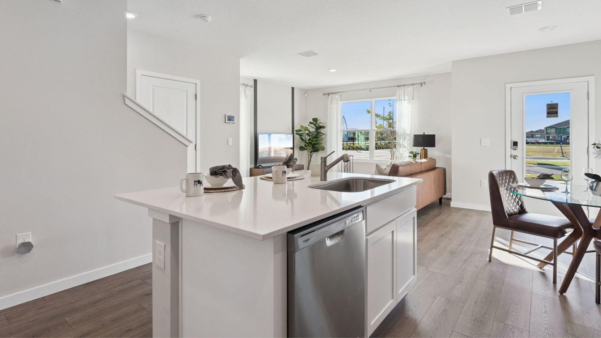kitchen with laminate flooring and quartz counters
