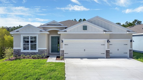 Single story new home with large windows and 3 car garage.