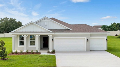 Single story new home with large windows and 3 car garage.