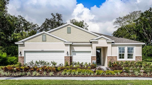 Single story new home with large windows and 3 car garage.