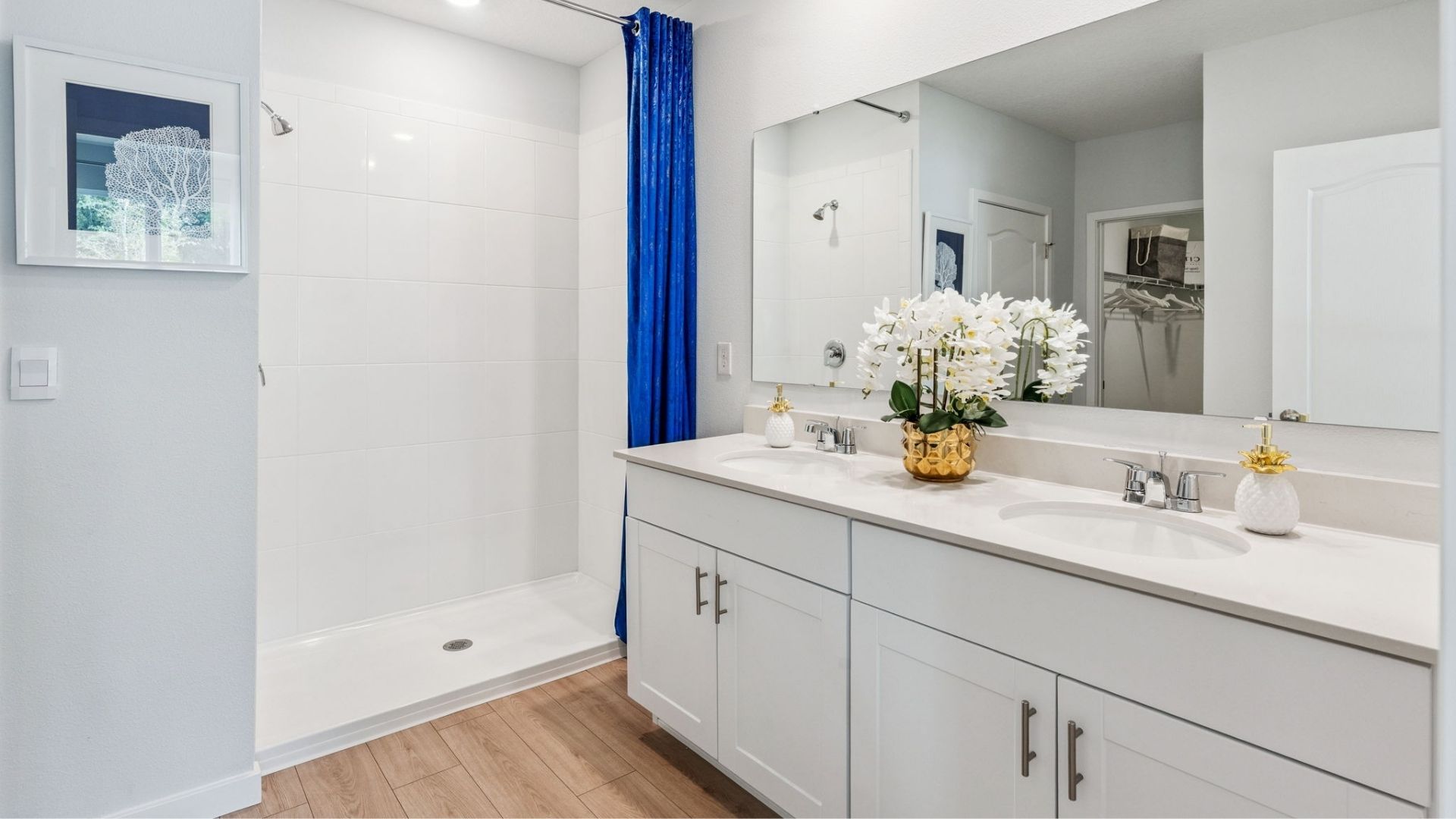 primary bathroom with quartz counters and laminate flooring