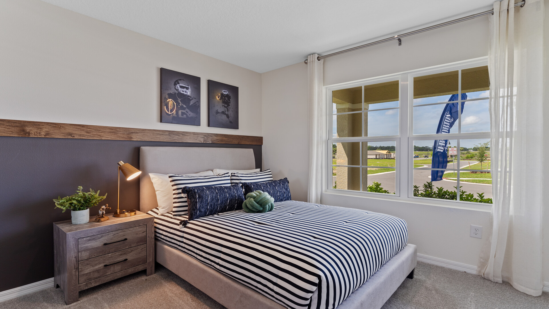 Guest bedroom with bed, nighstands and natural lighting.