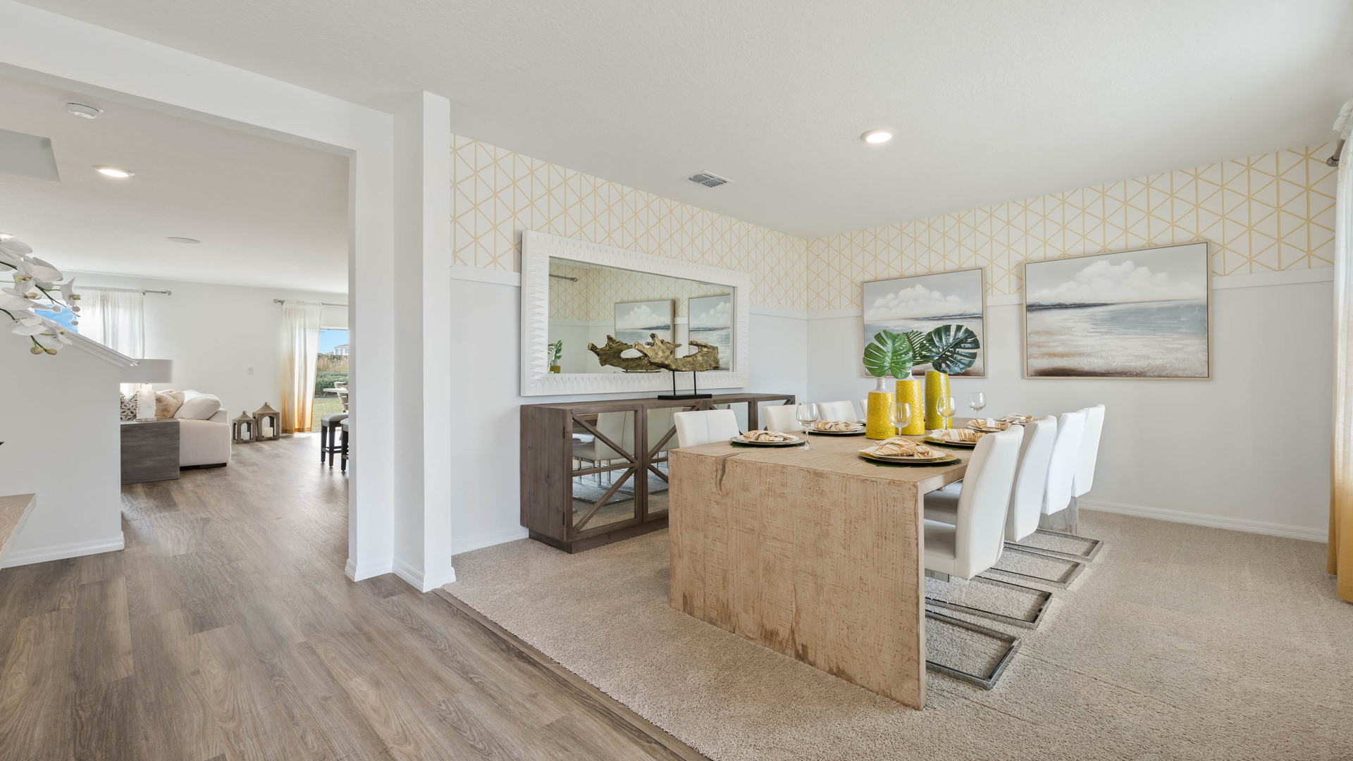 Entry to home showing front door with luxury vinyl plank flooring overseeing dining room table.