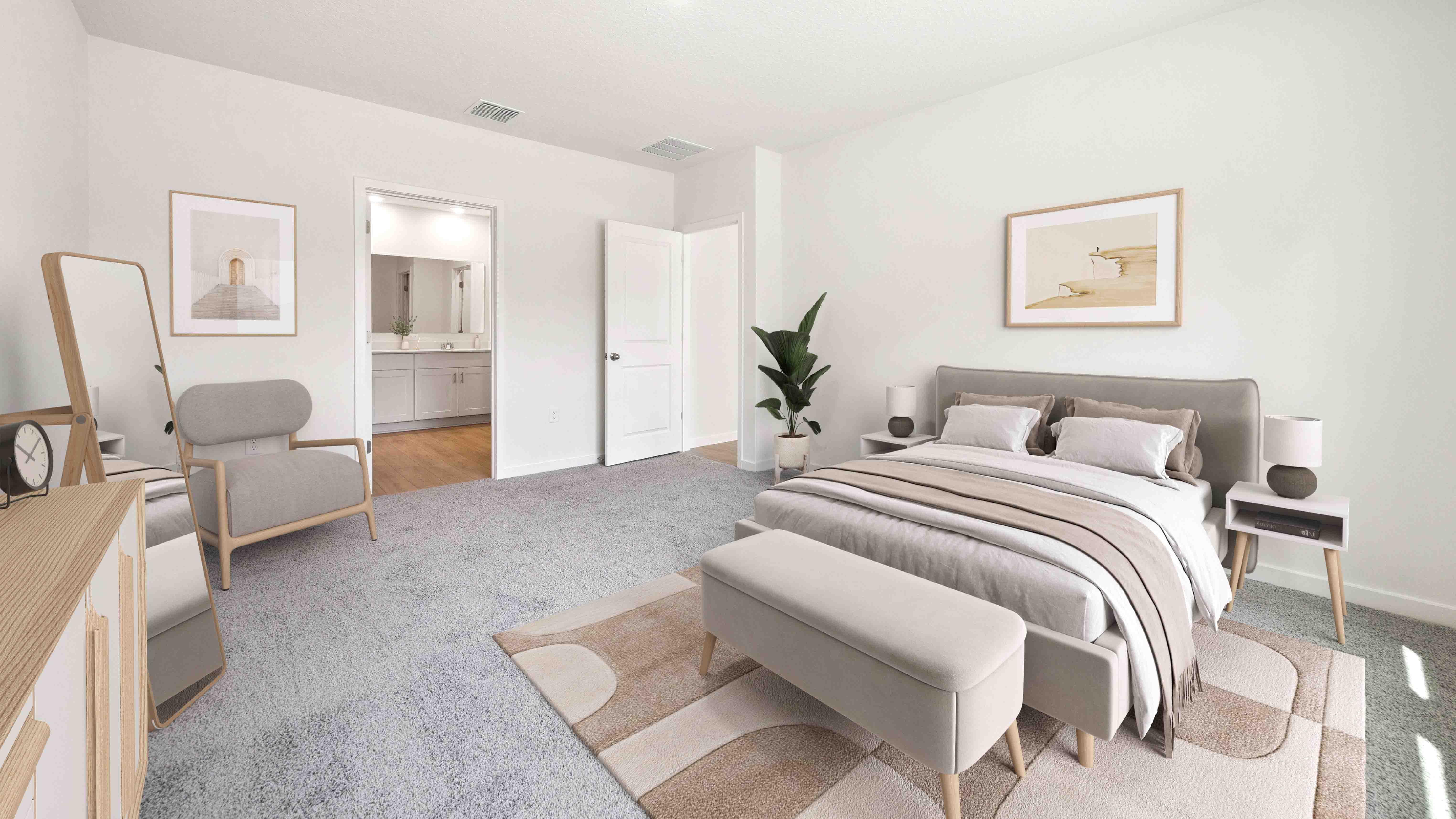 Spacious primary bedroom with king size bed, carpet flooring, natural lighting.