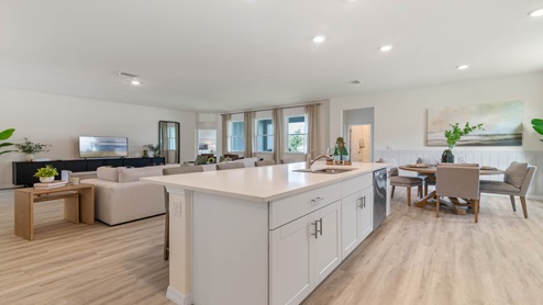 Kitchen with tall cabinetry, appliances, walk in pantry and Luxury vinyl plank flooring.