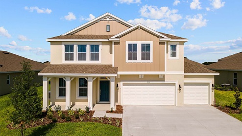 Two-story new home with porch siding and 3 car garage.