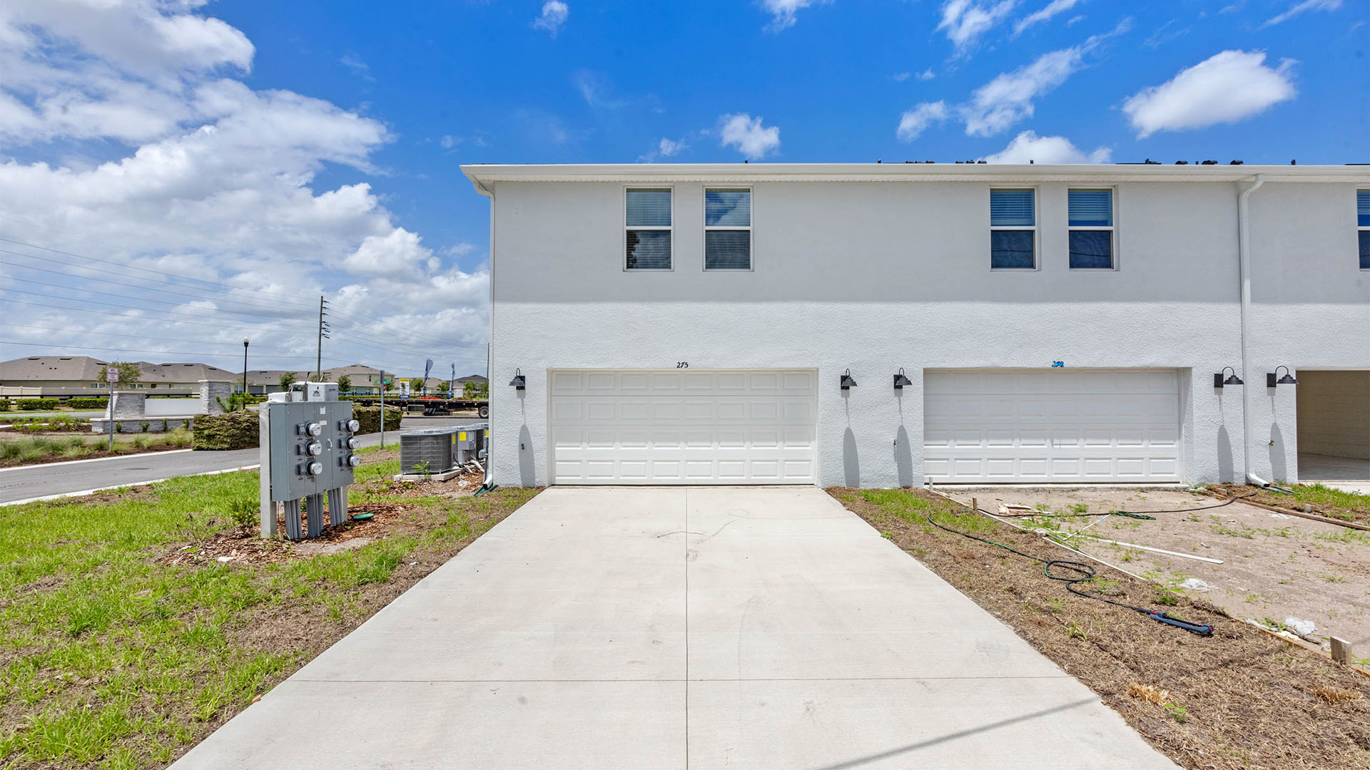 Rear of home showing two car garage driveway.