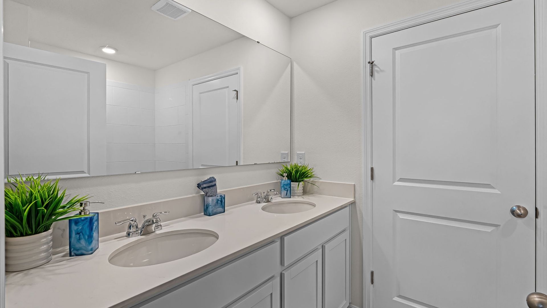 primary bathroom with quartz counters double sink and revwood select flooring
