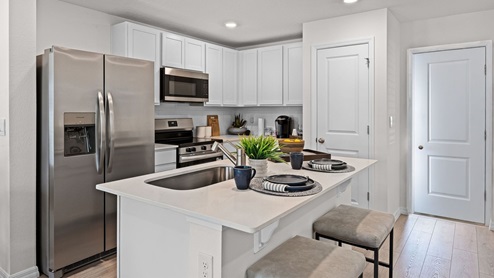 Townhome kitchen. Quartz counters and revwood flooring