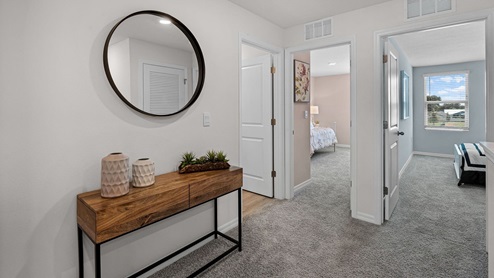 carpeted hallway leading to guest rooms