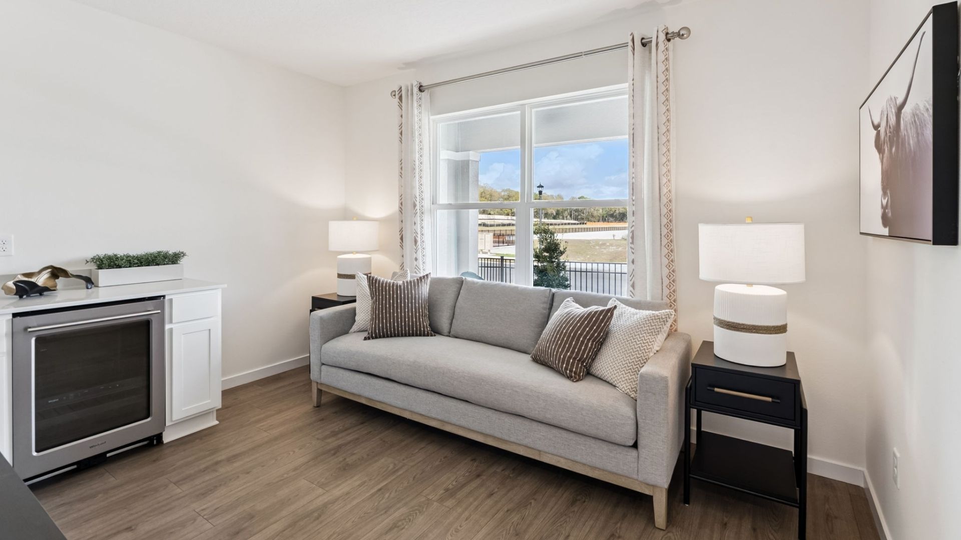 Spacious primary bedroom with king size bed, carpet flooring, natural lighting.