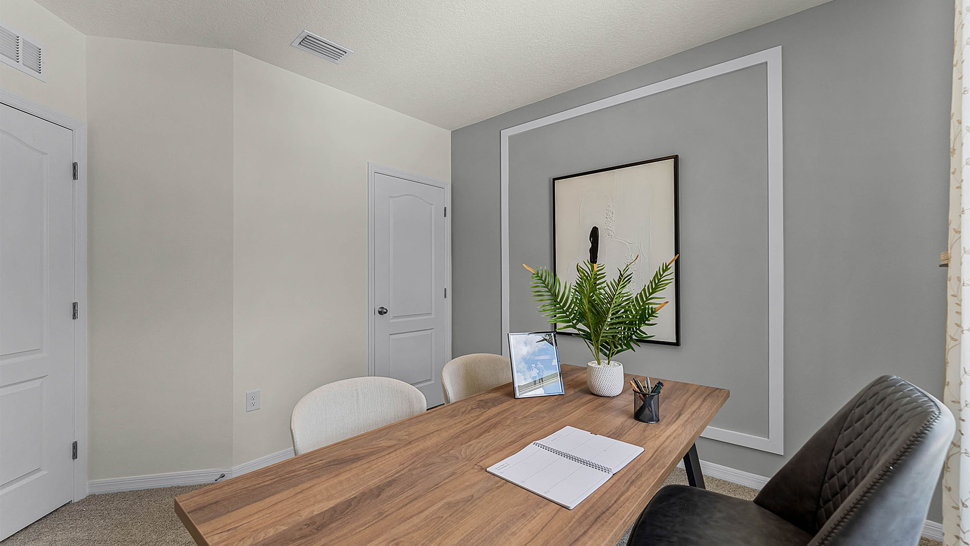Functional home office with desk, chairs and space to work or play.