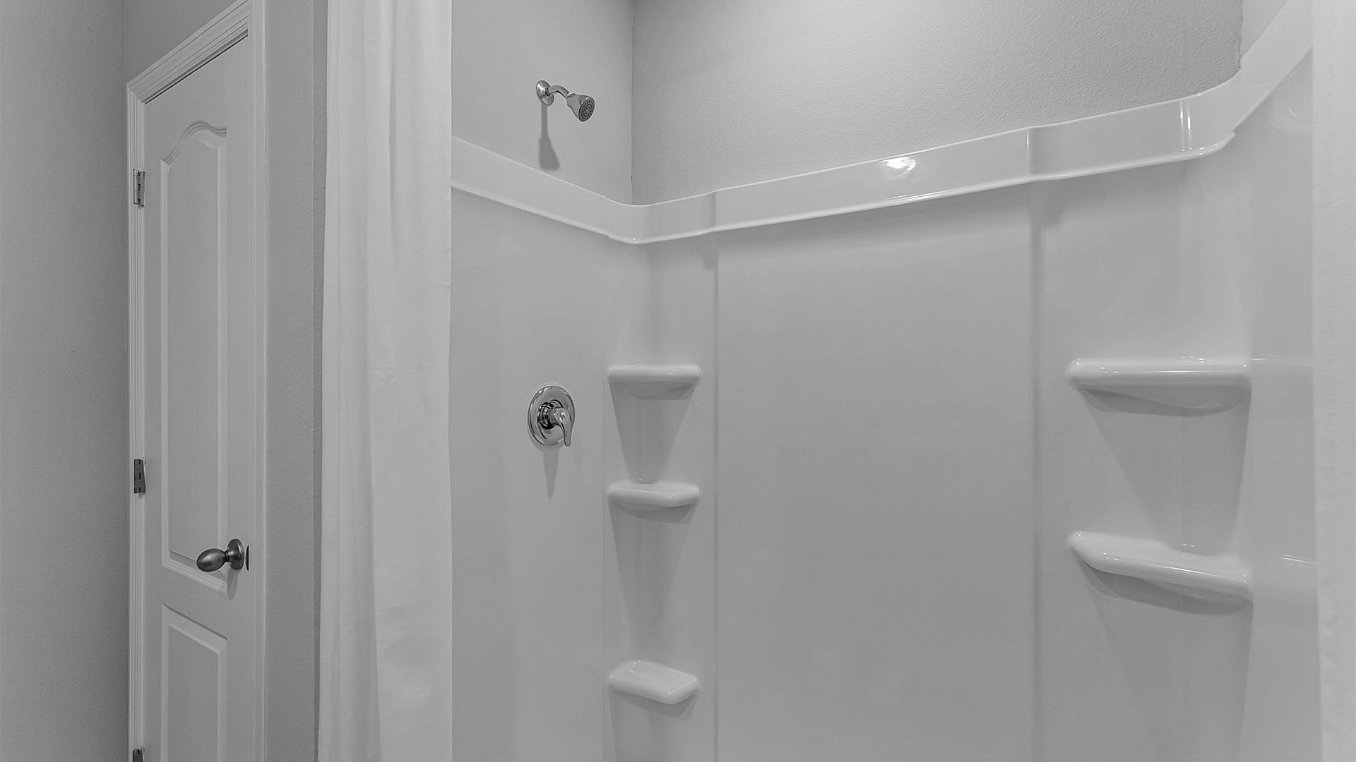 Walk-in shower next to spacious storage closet.