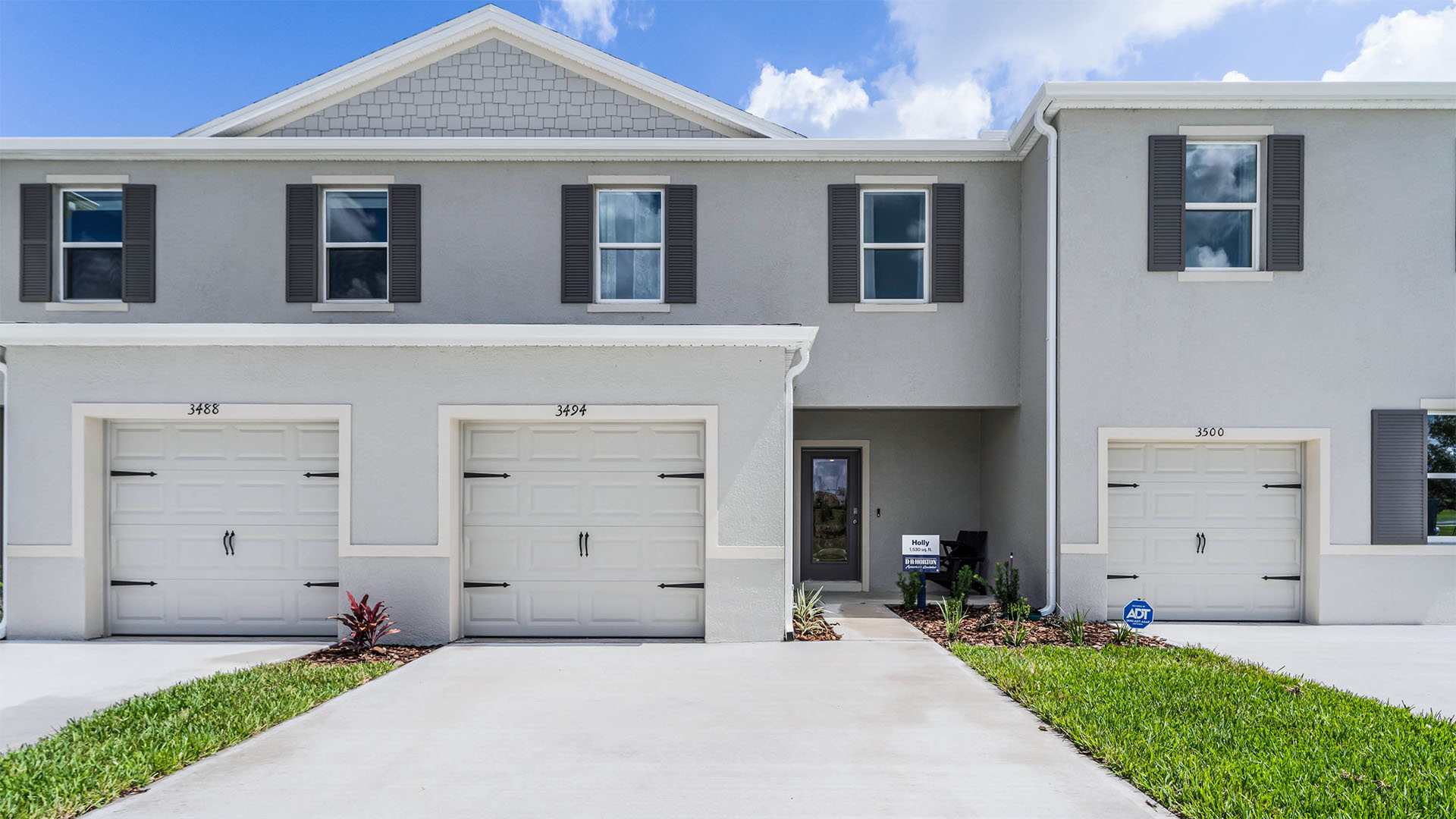 Attached townhome with concrete block construction and a one-car garage.