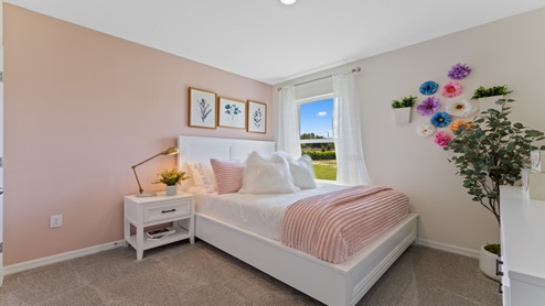 Guest bedroom with bed, nightstands and a roomy closet for storage.