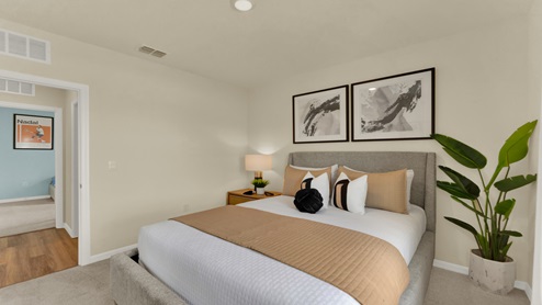 Guest bedroom with bed, nightstands and a roomy closet for storage.