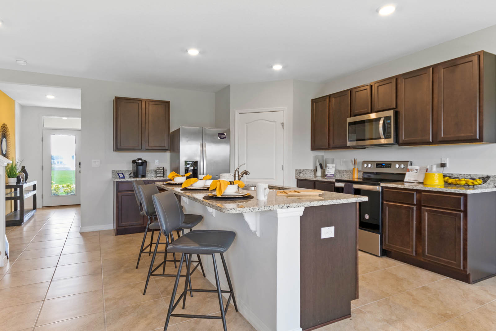 Kitchen with island and view of the entryway