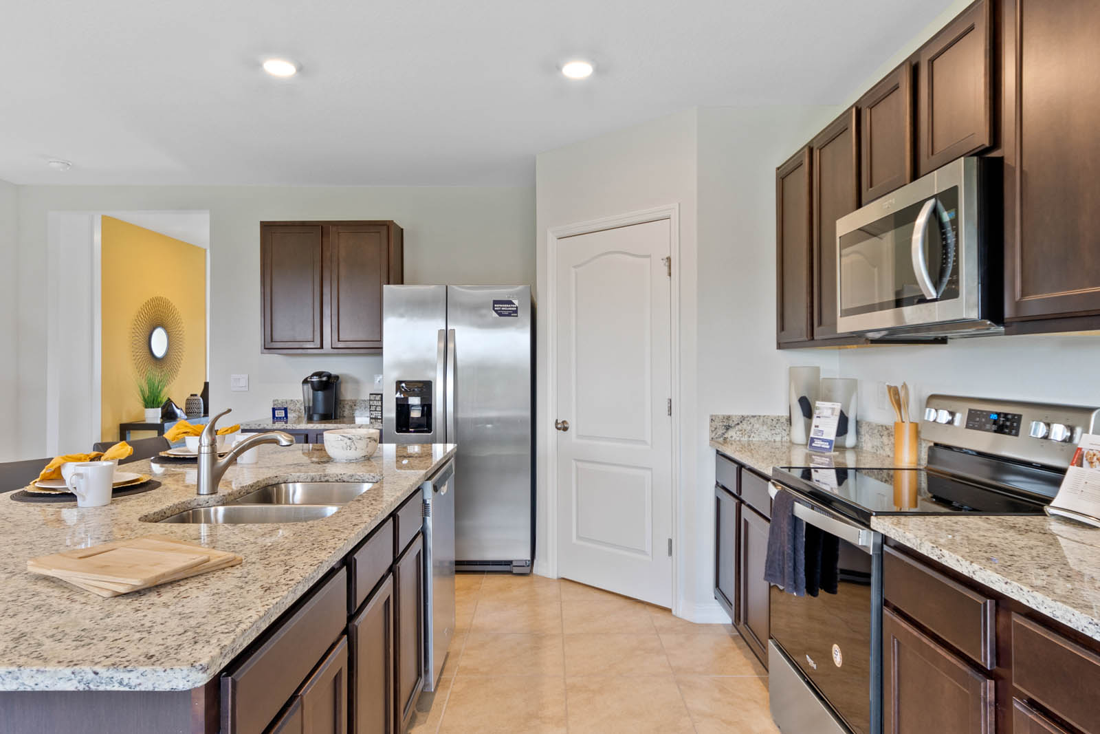 Kitchen with island and stove, microwave and fridge