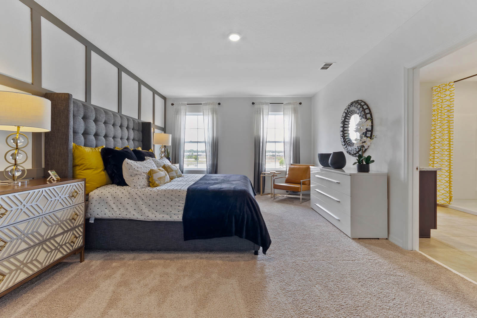 Primary bedroom with bed and spare chair