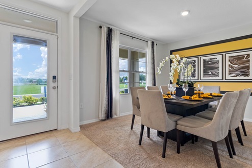 entry way of the home with carpet in the dining area