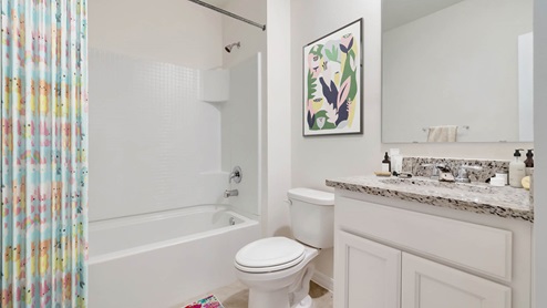 Virtually staged guest bathroom with tub