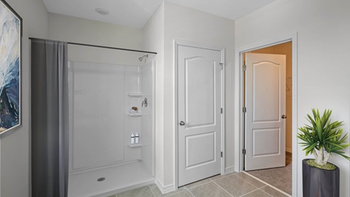 Virtually staged primary bathroom with walk in shower