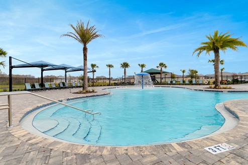 Resort-style pool with cabanas and seating