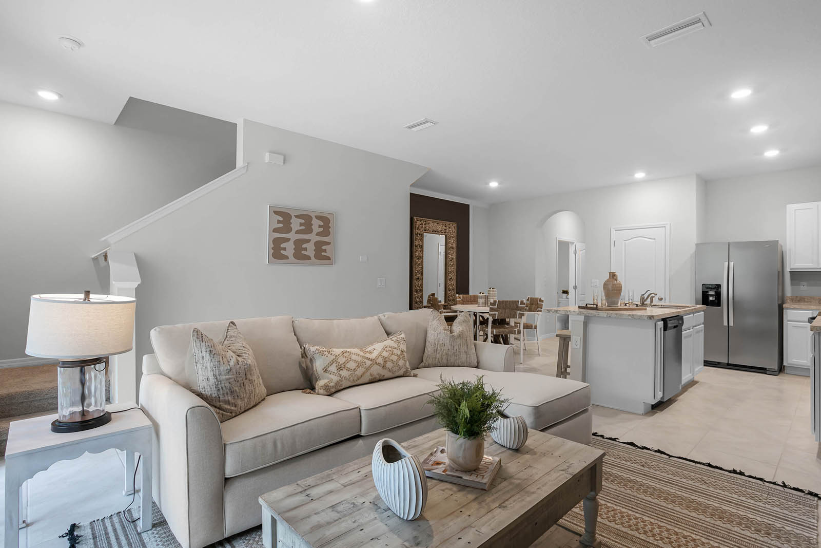 Living room with sofa and stairs to second floor