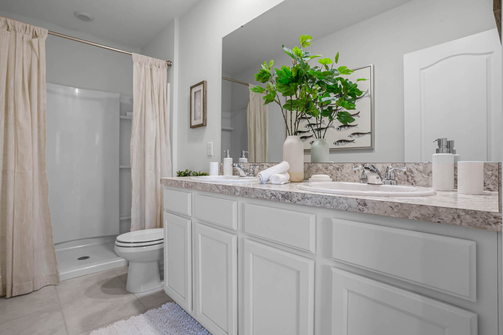 Primary bathroom with double vanity sinks and walk in shower