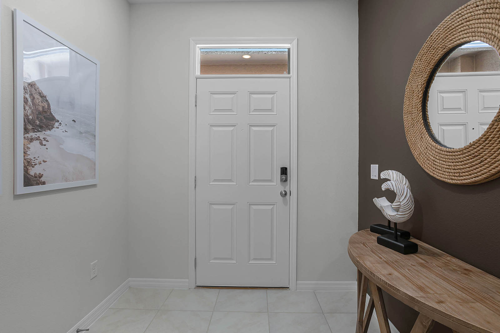 Entrance with table, mirror and artwork