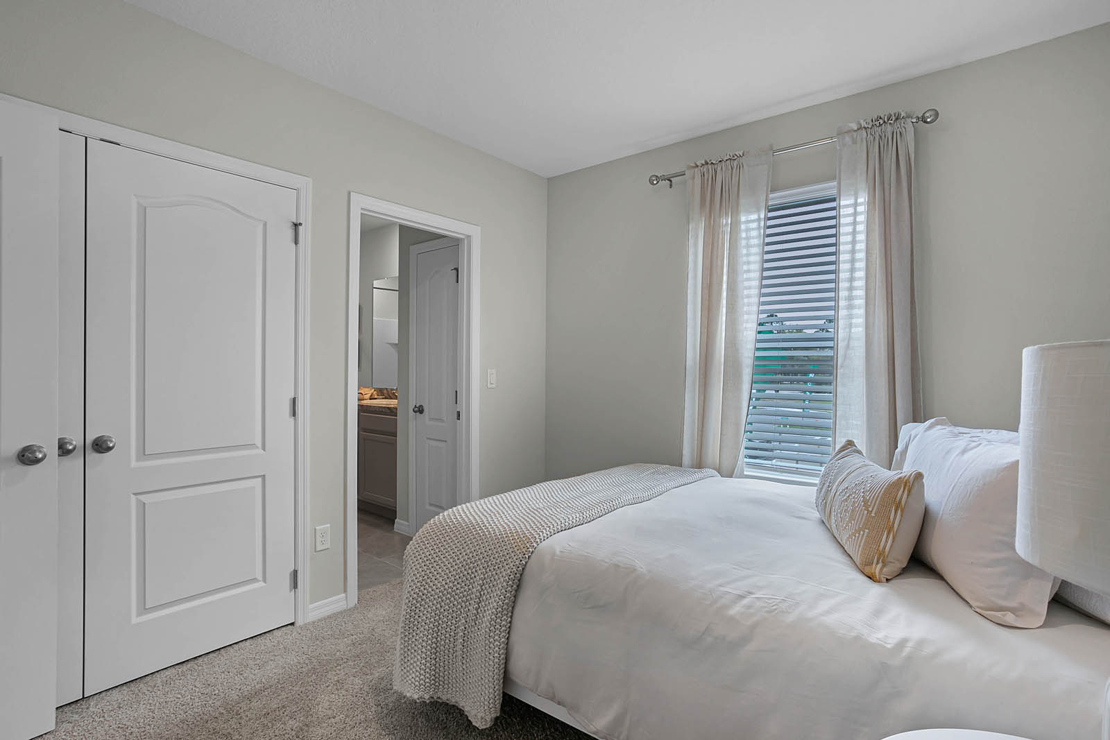 Guest bedroom with full size bed and attached shared bathroom