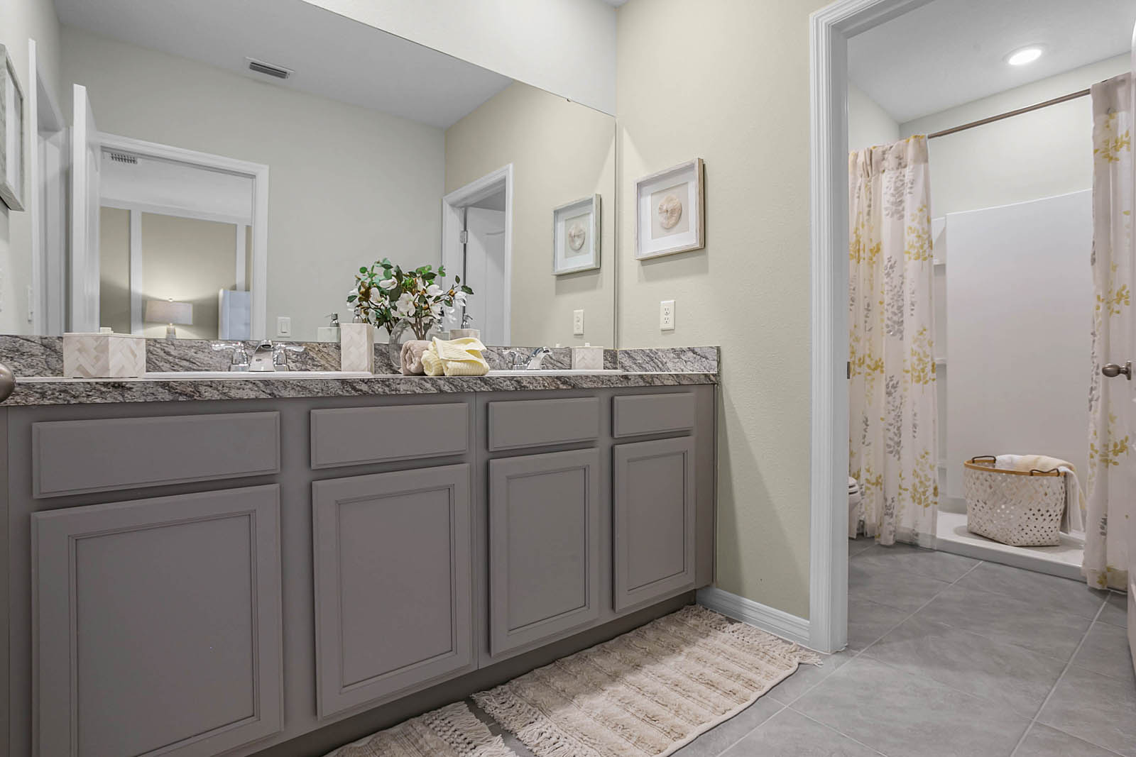 Primary bathroom with double vanity sinks and walk in shower