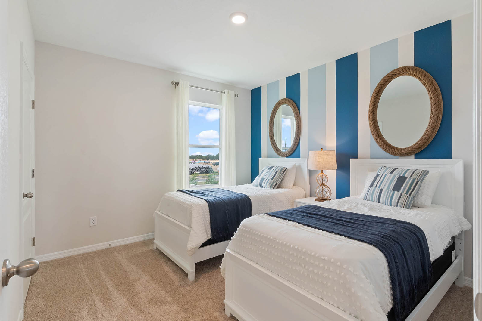 Guest bathroom with two twin beds and carpet throughout