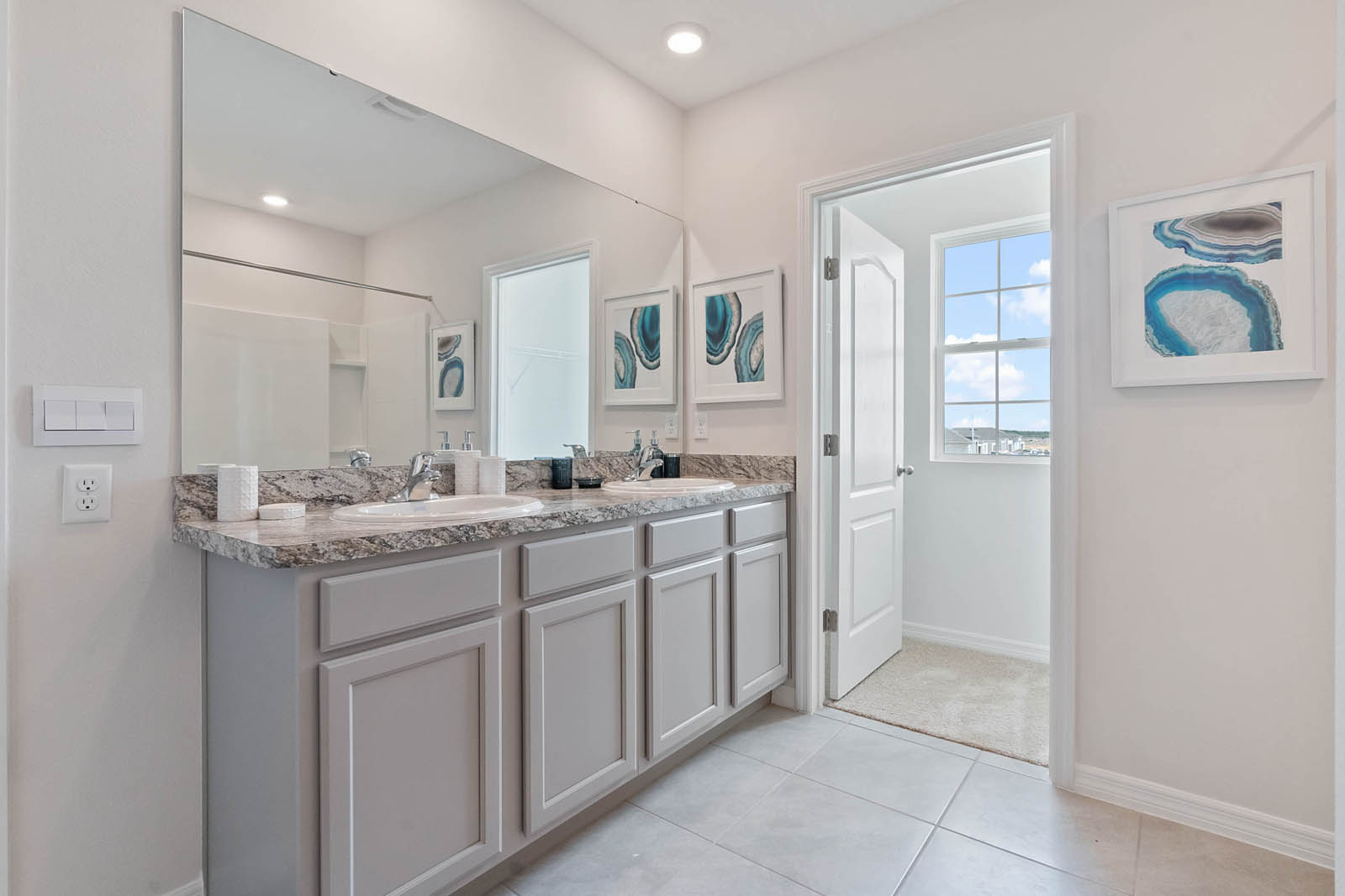 Primary bathroom with ceramic tile and double vanity sink