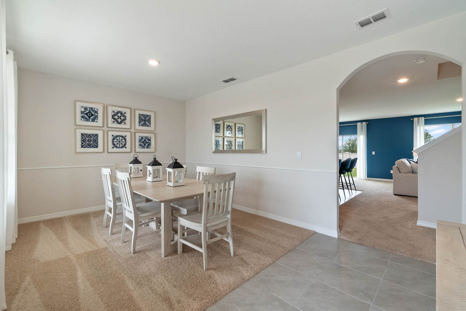 Foyer and dining room with carpet throughout