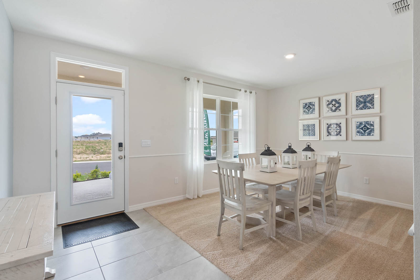 entrance to the home with ceramic tile and dining room to the right