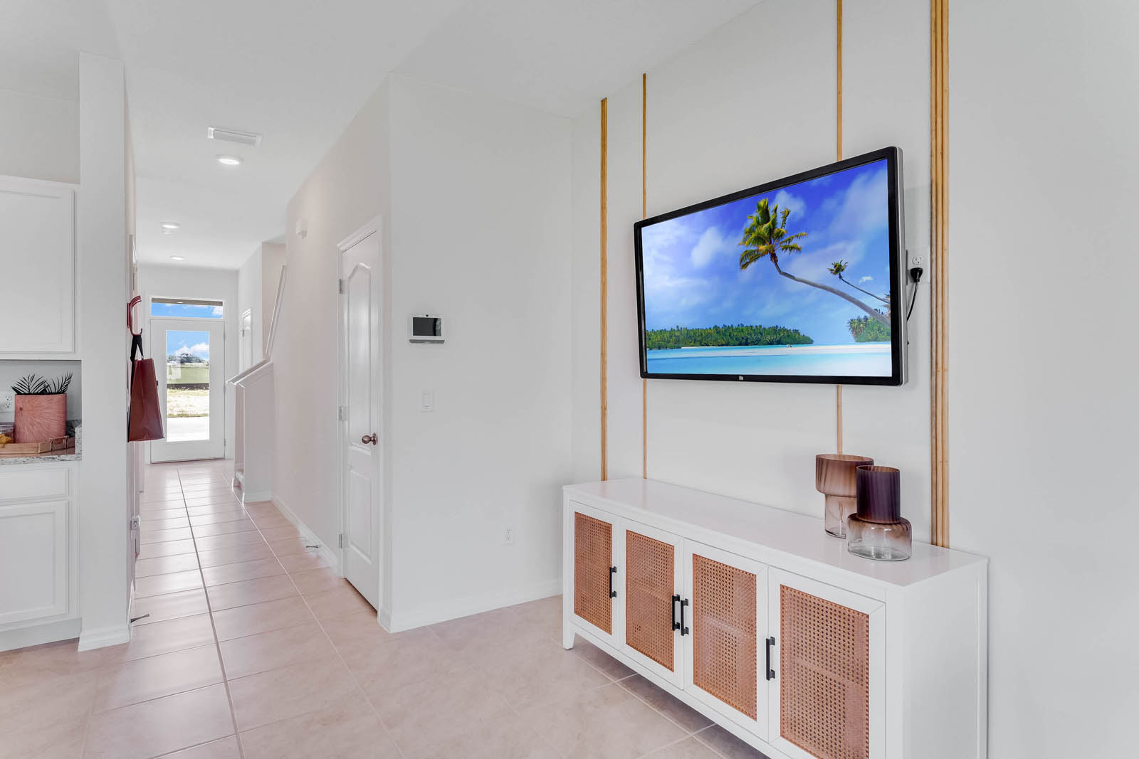 Dining room staged for a sales office with cabinet and tv