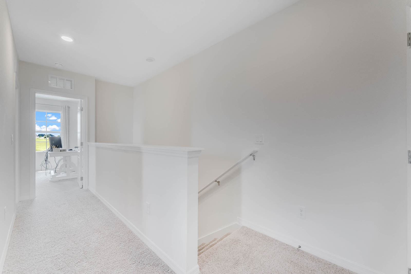 Upstairs hallway with stair access and hallway to guest rooms