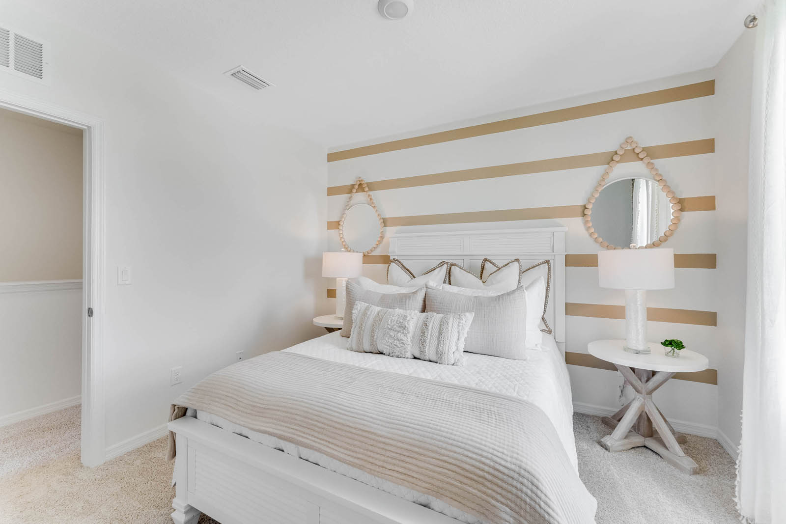 Guest bedroom with queen size bed and entrance to hallway