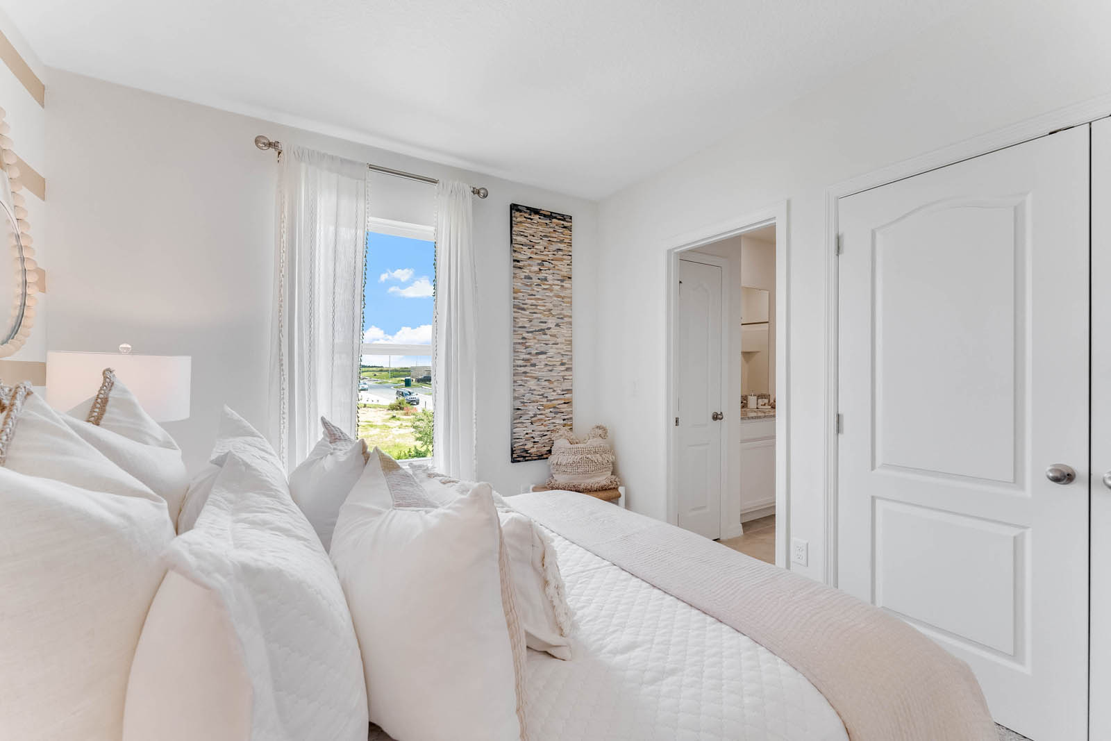 Guest bedroom with closet and attached shared bathroom