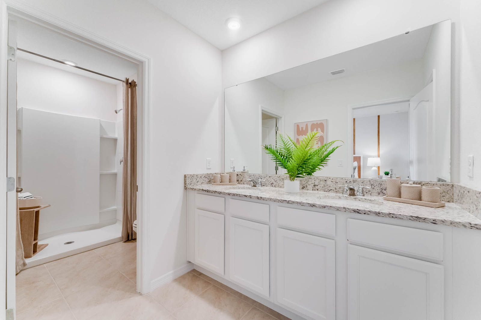 Primary bathroom with walk in shower and double vanity sinks