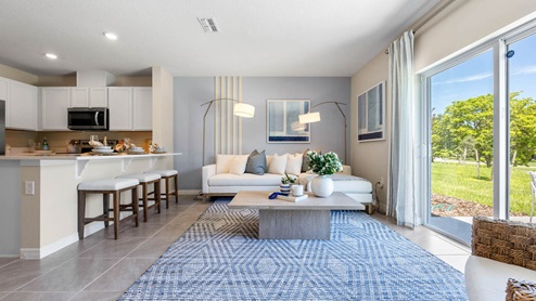 Living room with sectional couch and patio doors