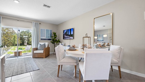 Dining room with 4 person round table looking to the living room