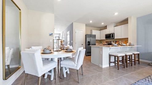Dining area overlooking the kitchen with island and additional seating