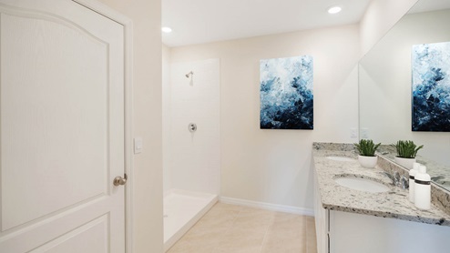 Virtually staged primary bathroom with walk in shower