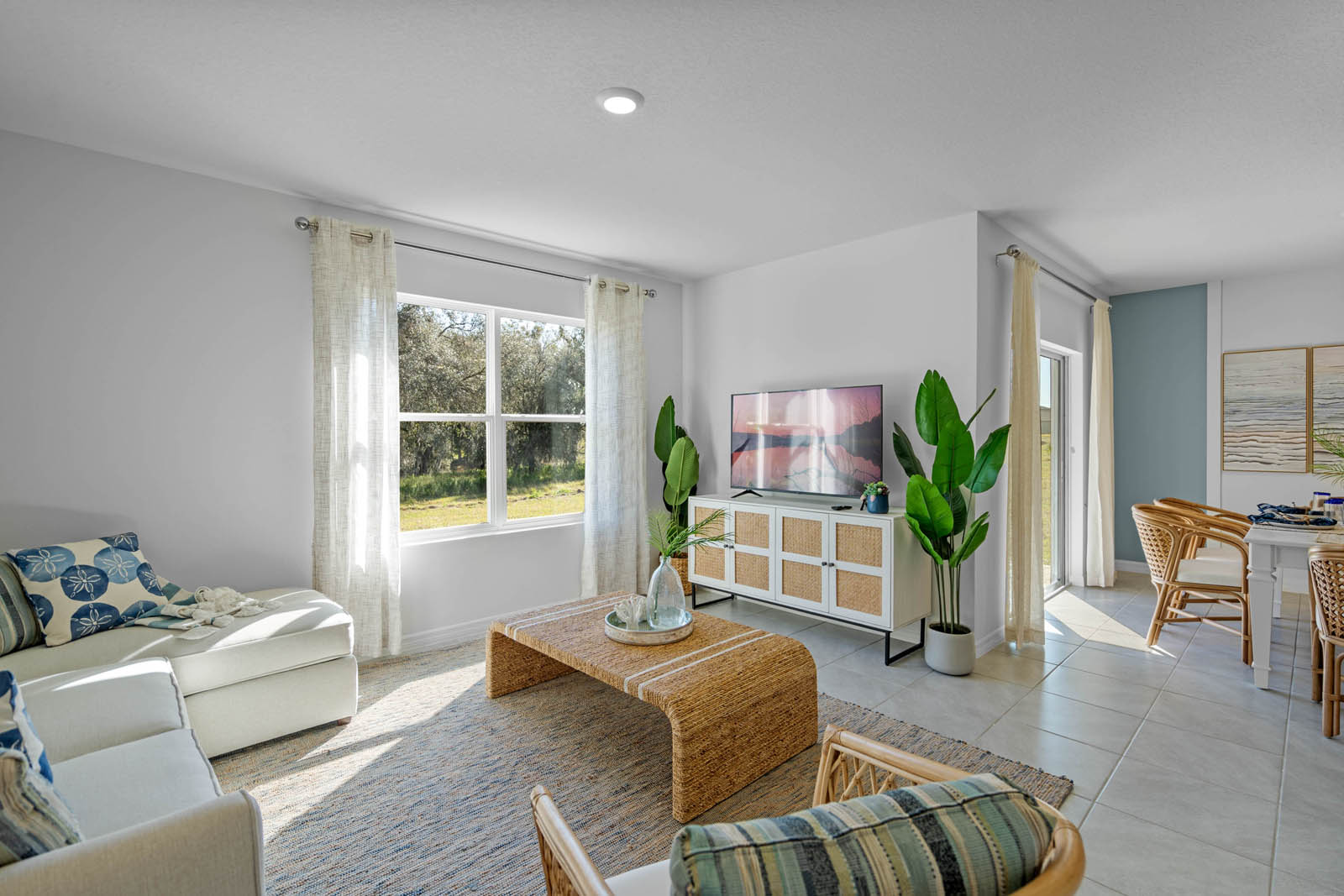 Living room space with window view of the backyard