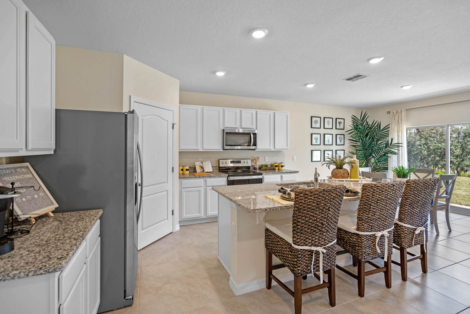 Kitchen with pantry on the left and dining table near the sliding glass door