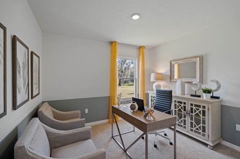 Office space with 2 chairs a desk and window